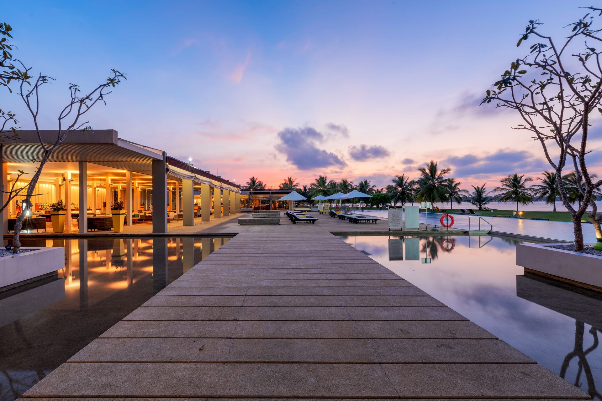 Wooden bridge leading to the pool deck at Amaya Beach Pasikudah