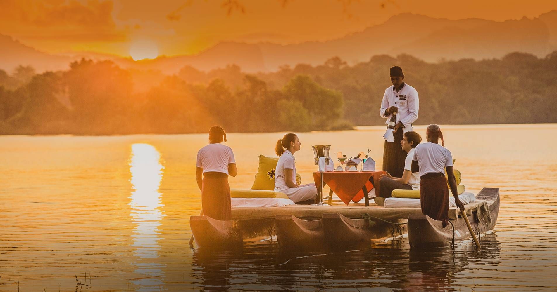 A couple being served drinks on a traditional boat