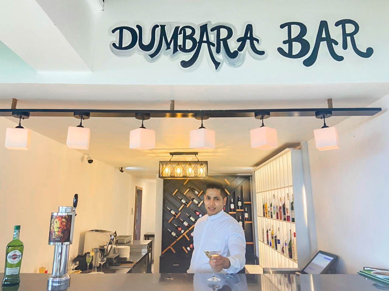Bartender offering a drink at Dumbara bar in Amaya Hills Kandy