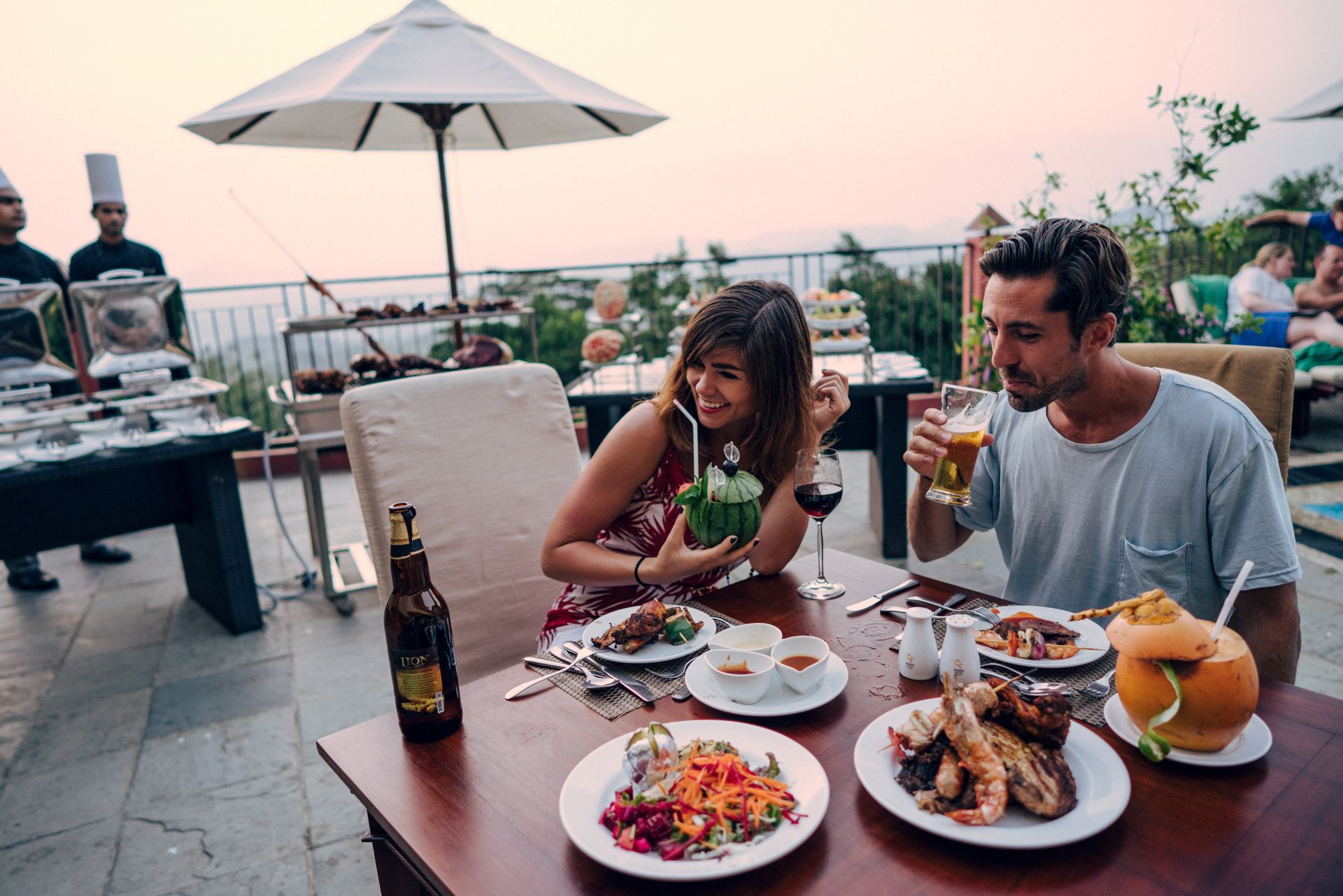 Couple enjoying dinner and drinks outdoors