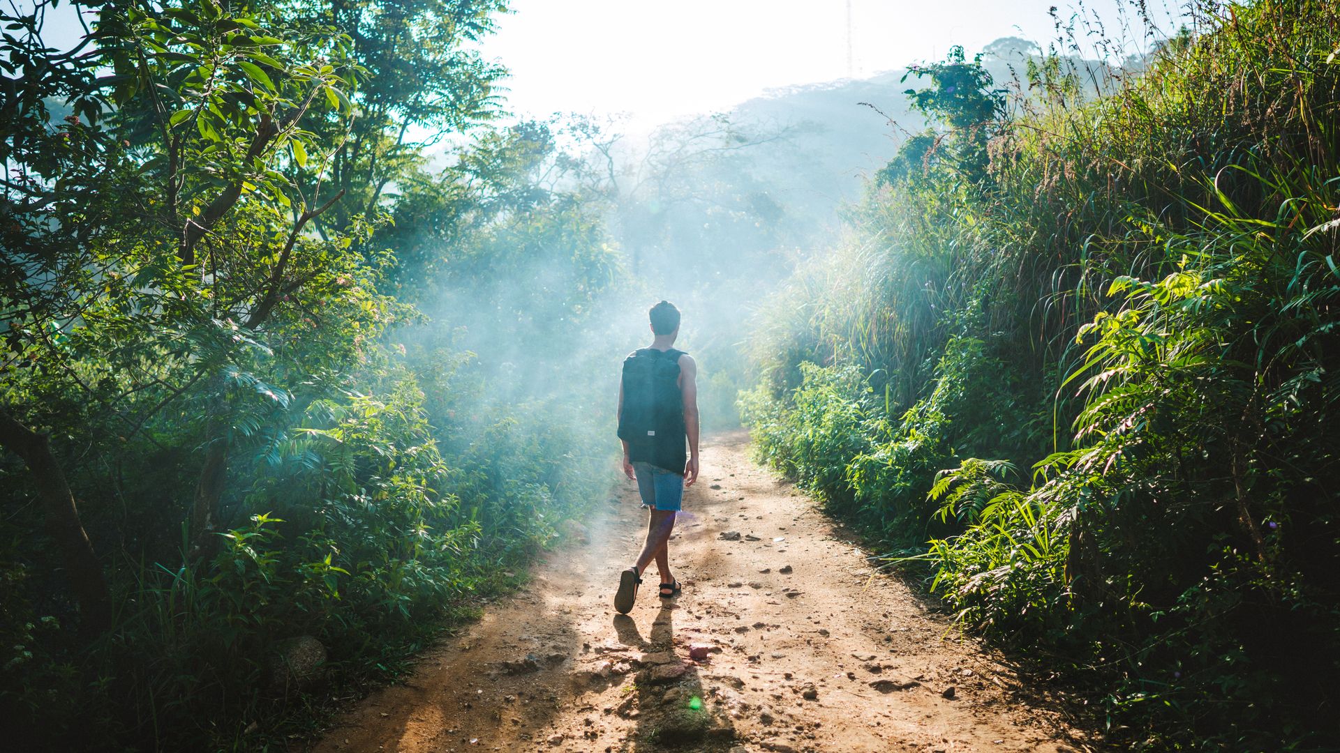 A guest hiking along a trail 