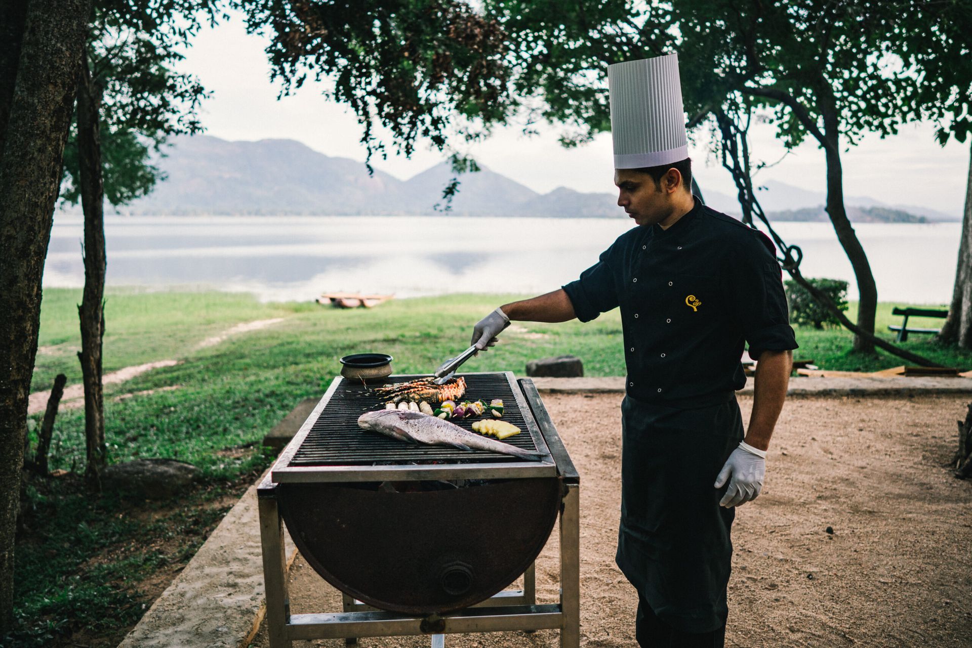 A chef grilling seafood by the lake 