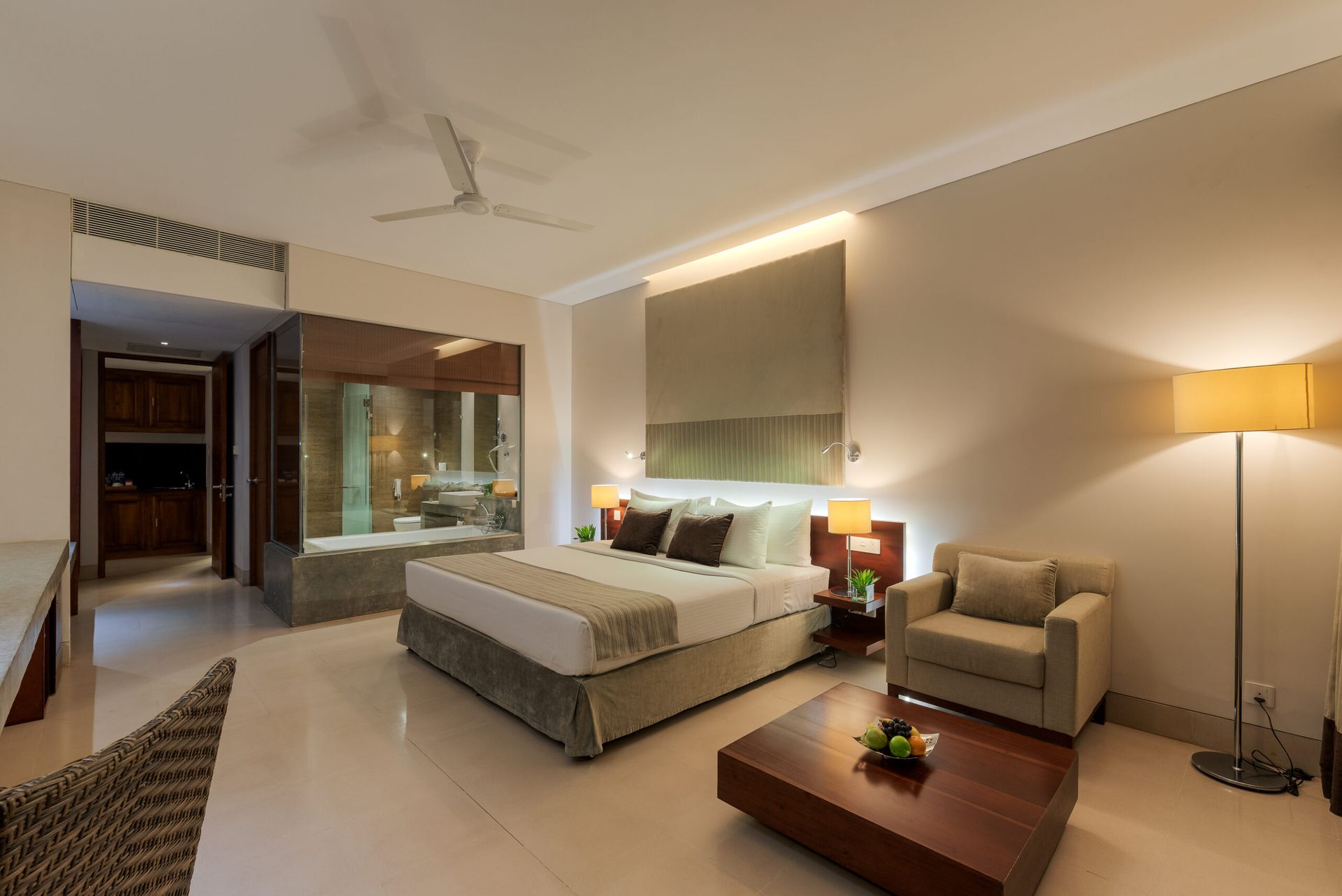 Bed and sitting space of a standard room at Amaya Beach Pasikudah